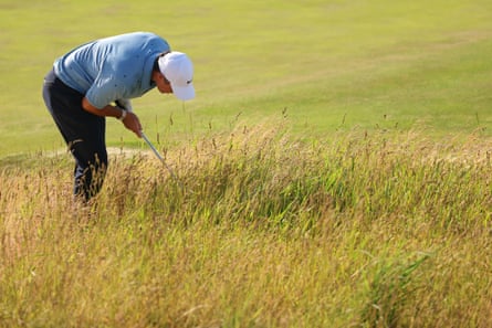 Rory McIlroy looks for his ball on the 18th hole during the third round of the US Open