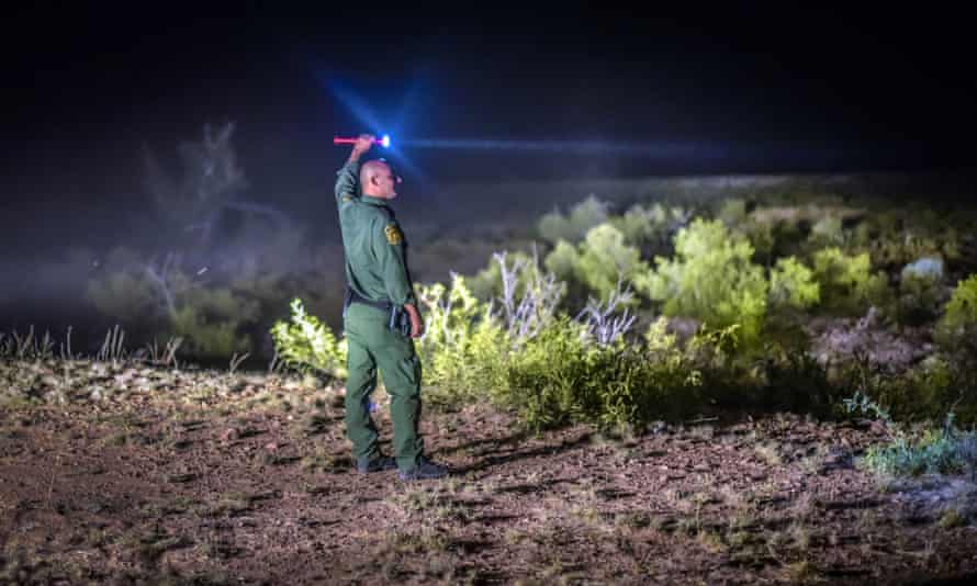 A Border Patrol agent searches the terrain in the Animas mountains in New Mexico’s boot heel.