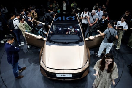 People gather next to the new IONIQ V electric vehicle