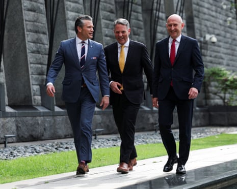 Australian defence minister Richard Marles, centre, walks alongside US and UK counterparts Pete Hegseth (L) and John Healey (R) at the US embassy in Singapore