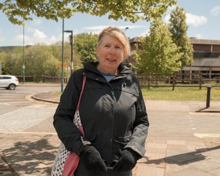 Helen, on the side of a road with her shopping bags in Tredegar