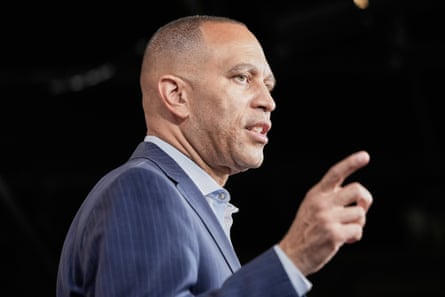 man in suit speaks with finger pointed
