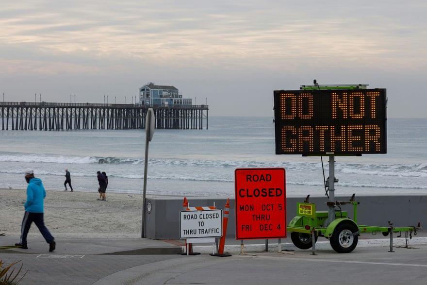 A sign in Oceanside, California, warns against gathering as the new stay-at-home orders take effect.