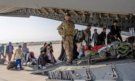 British citizens and dual nationals board a military plane at Kabul airport.