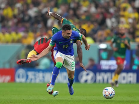 Brazil's Gabriel Martinelli loses his shoe as he’s tackled by Cameroon's Collins Fai.