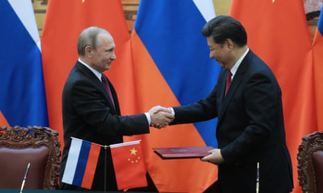 Russia’s president Vladimir Putin and China’s president Xi Jinping shake hands at the signing of documents following Russian-Chinese talks. 