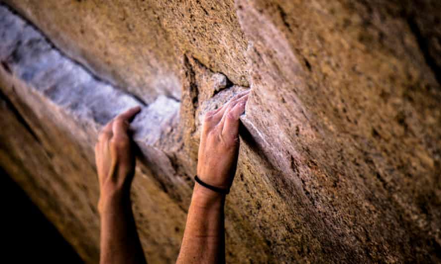 Man hanging from a rockface