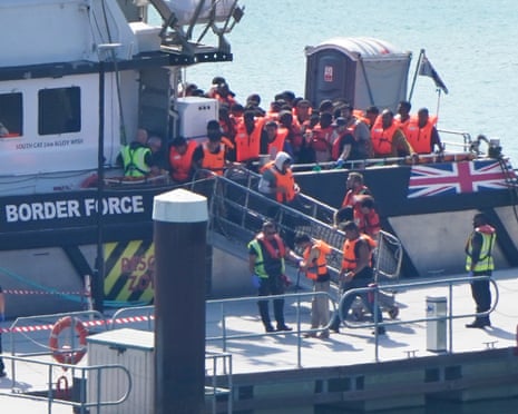 A group of people thought to be migrants are brought in to the Border Security Command compound in Dover, Kent, last month