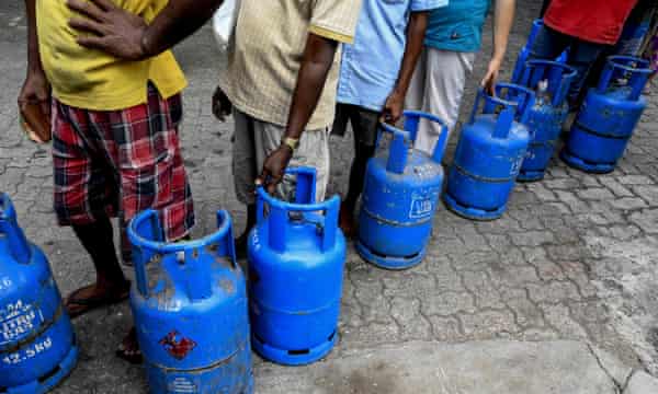 People queue to buy Liquefied Petroleum Gas cylinders in Colombo as shortages of essentials gripped the island