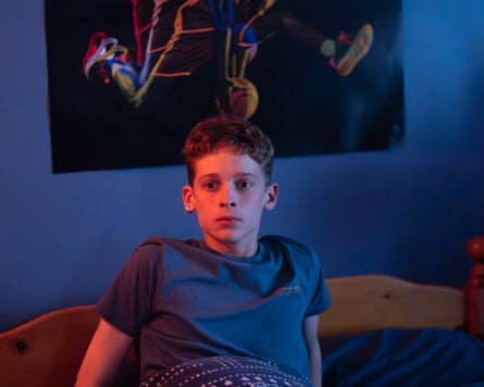 Boy in bed, looking anxious.