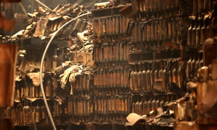 Burned bottles of wine sit in a storage facility destroyed by the Glass fire in 2020 in California.