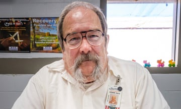 white man with mustache and beard wearing glasses and white shirt