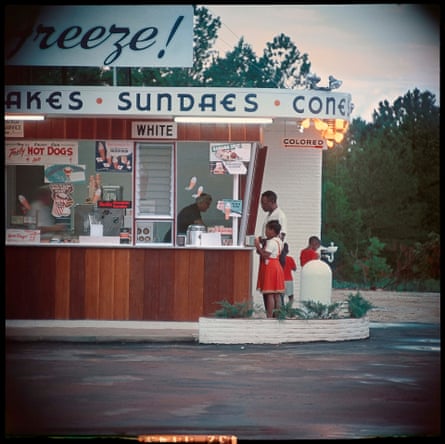 A family of four getting ice cream from segregated Sundae store, 1956