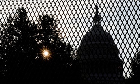 FILE PHOTO: The sun rises behind the U.S. Capitol, surrounded by a security fence ahead of an expected rally Saturday in support of the Jan. 6 defendants in Washington, U.S. September 16, 2021. REUTERS/Jonathan Ernst/File Photo