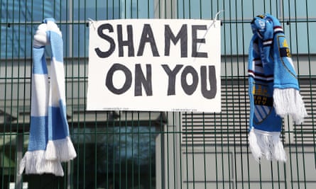 A sign between two Manchester City scarves outside the Etihad Stadium.