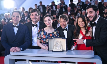 Karren Karagulian, Alex Coco, Mikey Madison, Sean Baker, Samantha Quan and Vache Tovmasyan pose with the Palme d’Or at Cannes.