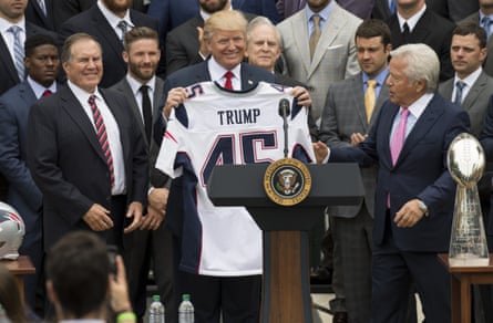 Donald Trump holds a New England Patriots jersey standing next to Robert Kraft at the White House in 2017.
