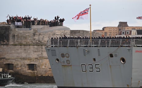 People wave goodbye as HMS Dragon sets sail from Portsmouth harbour.