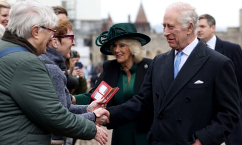 Charles and Camilla shake hands with members of the public