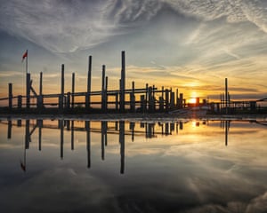 North Norfolk, UK ‘There’s a car park with loads of puddles bedside a quay in north Norfolk. If you look east at dawn, you get sunrise with the wooden structures silhouettes in front on the morning sky. If you get down low you get fantastic reflections as well.’