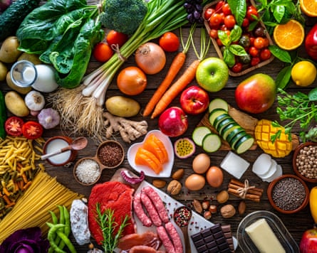 A variety of food types including fruit, vegetables, meat and dairy on a table