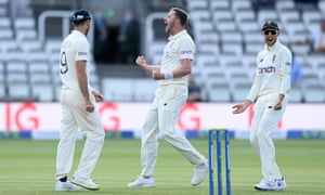 Ollie Robinson of England celebrates the successful review and dismissal of Kane Williamson of New Zealand with James Anderson and Joe Root.