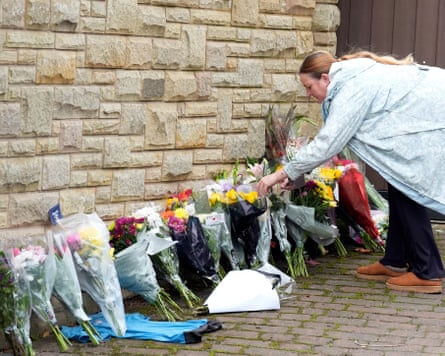 A personification lays a floral tribute successful representation of Ricky Hatton astatine his home