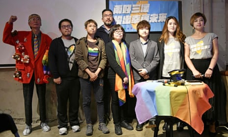 LGBT activists pose for photos during a press conference in Taipei after the referendum approving same-sex marriage failed to pass.