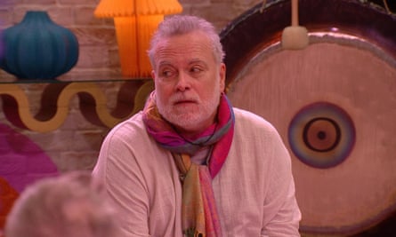 Man in colourful scarf sitting