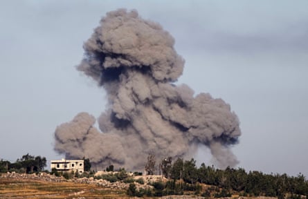 Smoke rises into the air over buildings after an Israeli airstrike