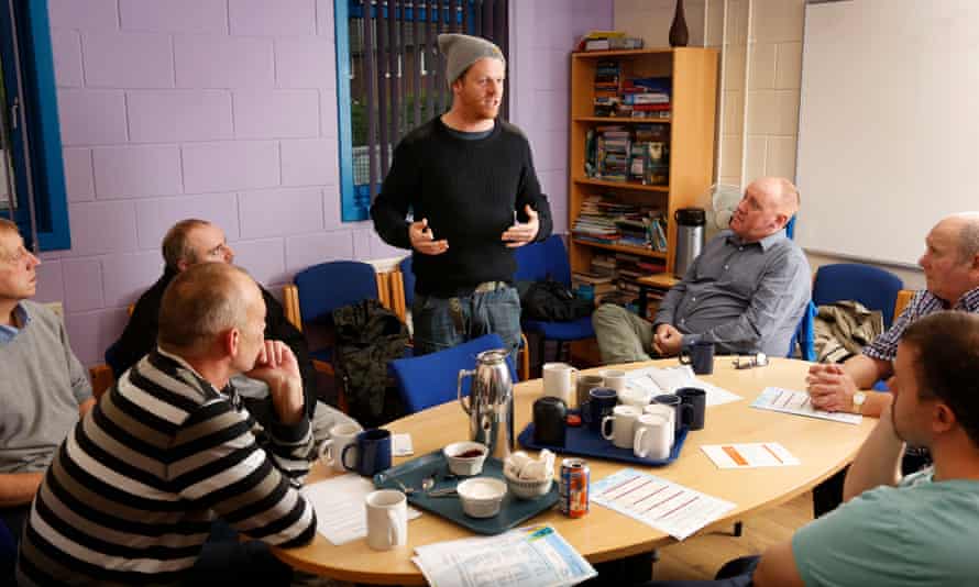 Darren McGarvey rapping and talking to a men’s group about domestic violence in Scotland