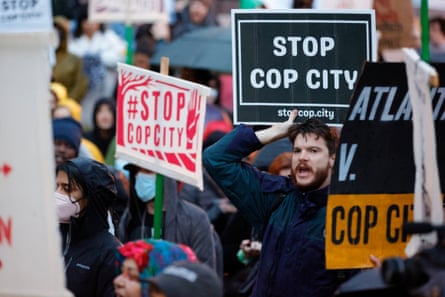 Demonstrators hold signs and chant slogans during a protest against the Cop City project on 9 March in Atlanta, Georgia.
