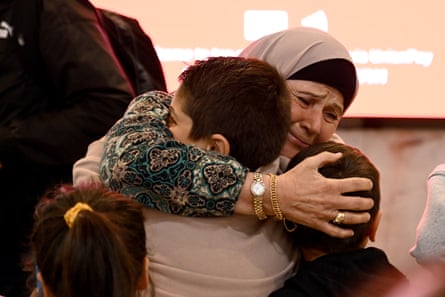 Family and friends embrace as Australian nationals arrive in Sydney on a repatriation flight from Lebanon on 8 October. Many Australian nationals remain in Lebanon.
