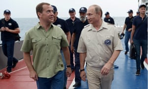 Russia’s prime minister, Dmitry Medvedev (left), and Putin walk to the C-Explorer submersible before going beneath the waves