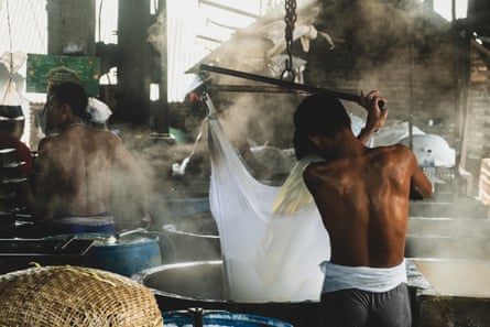 A worker at a tofu factory in Tropodo, Indonesia.