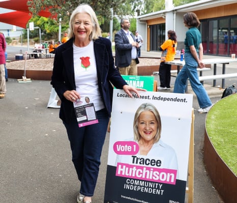Independent candidate for the seat of Nepean Tracee Hutchison stands next to a corflute bearing her face and name