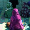 A composite of an afghan street and cutouts of unidentifiable afghan women