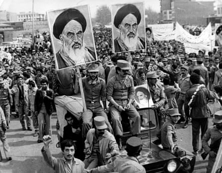 The Iranian Islamic Republic army demonstrates in solidarity with people in the street during the Iranian revolution. They are carrying posters of Ayatollah Khomeini.