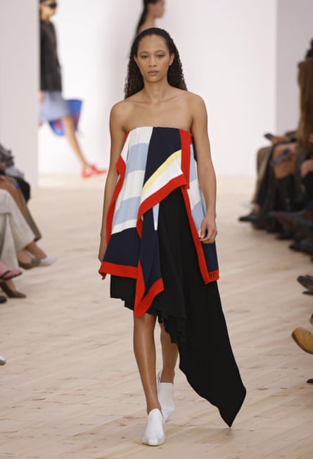 Model in a blue and red strapless dress on a catwalk