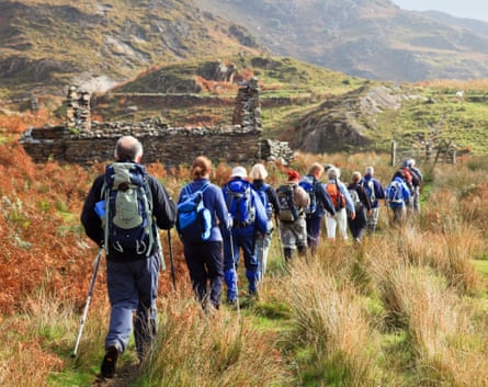 A group of ramblers walking in the Welsh mountains of Snowdonia national park.