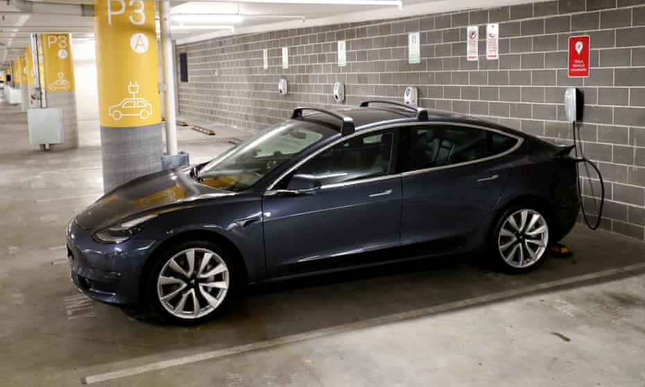 A Tesla Model Y charges at a EV charge station in Lane Cove, Sydney, Australia