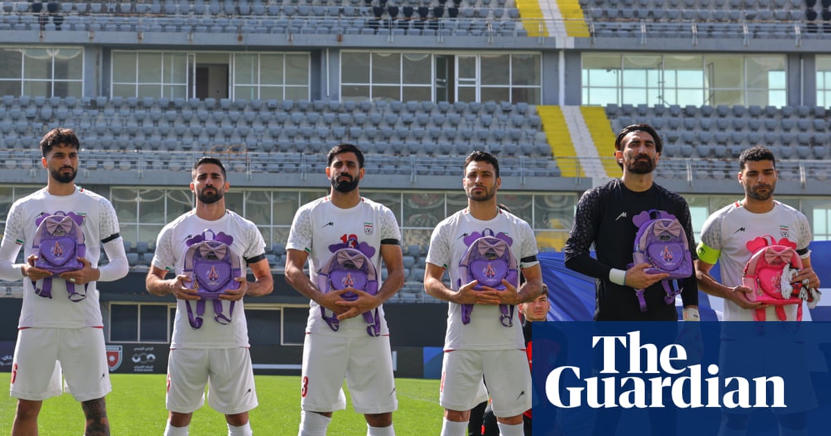 Iran footballers hold school bags in memory of girls killed in bombing