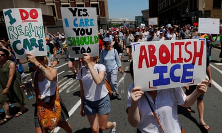 A demonstrator carries a sign reading ‘Abolish Ice’ at a ‘Families Belong Together’ rally in Boston on 30 June.