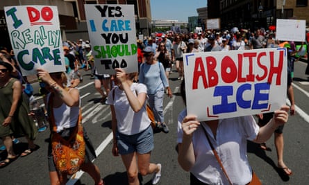 Demonstrators carrying ‘Abolish ICE’ and ‘I Really Do Care’ signs during the ‘Families Belong Together’ rally in Boston, Massachusetts, on 30 June 2018.