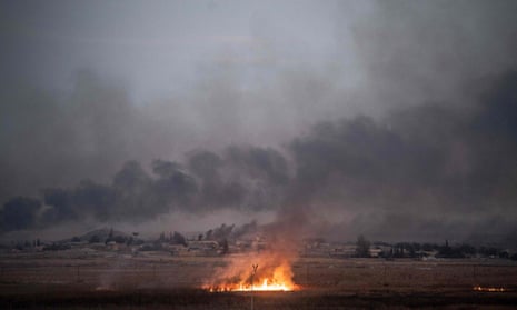 Smoke rises from the Syrian border town of Tel Abyad, following an offensive by pro-Turkish forces.
