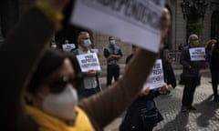 Demonstrators take part in a protest to condemn a police raid on Catalan separatists in Barcelona.