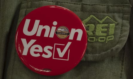 A union button is seen on an REI employee’s vest in New York City.