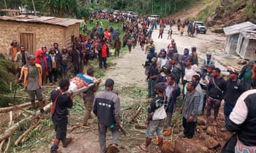 An injured person is carried on a stretcher after a landslide in Yambali village, Papua New Guinea, on Friday