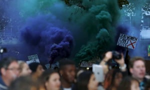 Demonstrators let off flares in the crowd