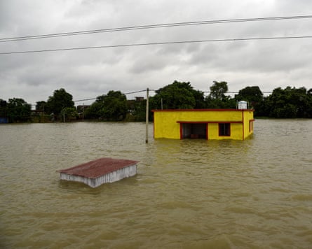 Two houses half covered by flood water
